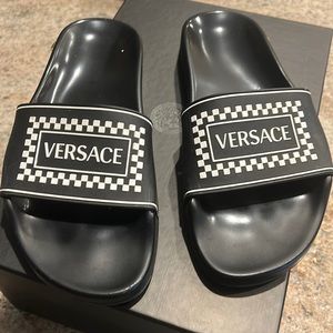 Black and white Versace slides.